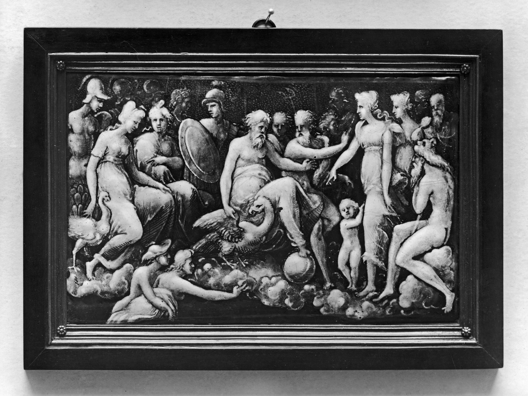 Museum photograph of a grisaille enamel plaque showing Mercury bringing Psyche to Mount Olympus, with white and gray figures painted over a dark ground