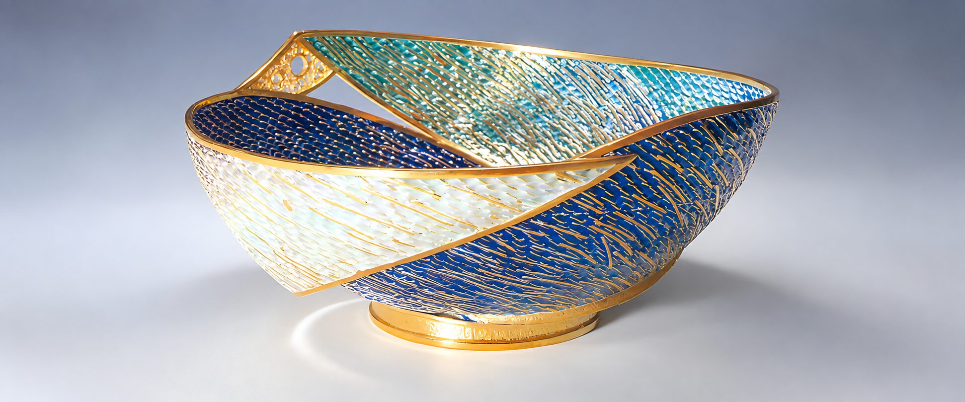 Plique-a-jour enamel bowl: translucent blue, turquoise and white enamel held in an open gold wire framework with no metal backing, so light passes through like stained glass